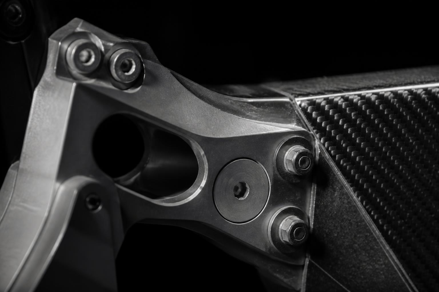 Machined structural bracket joined to a composite panel